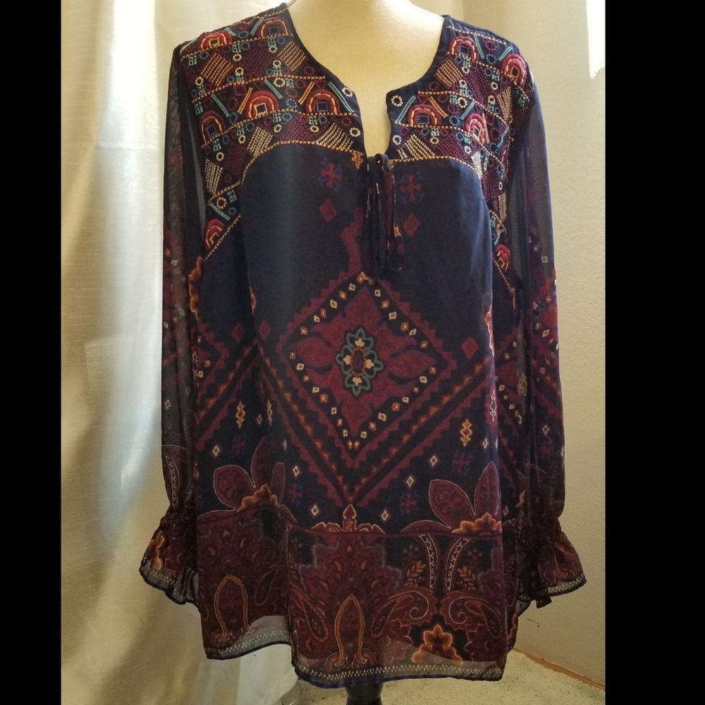 Sheer blouse with navy lining.